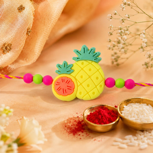 Close-up of a Pineapple Fruit Charm Rakhi for Brother with colourful beads.