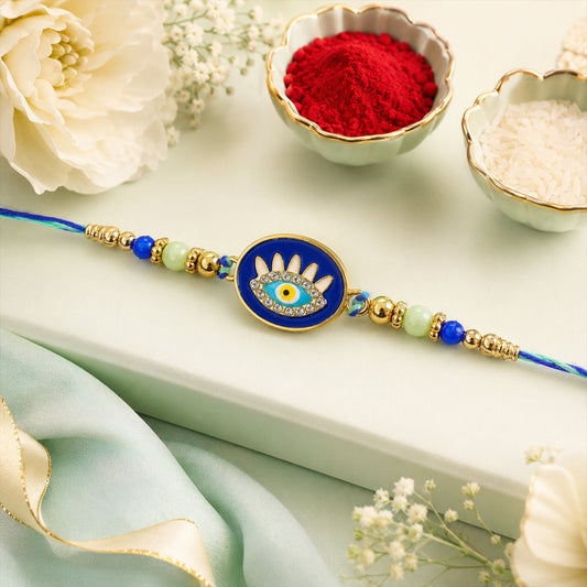 Evil Eye Rakhi with round beaded motif on a decorative background for Raksha Bandhan.