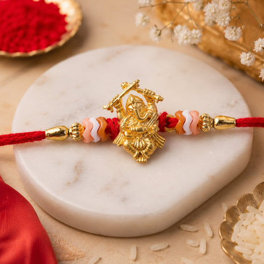 Close up of a Ganesha stone studded rakhi with intricate traditional design.