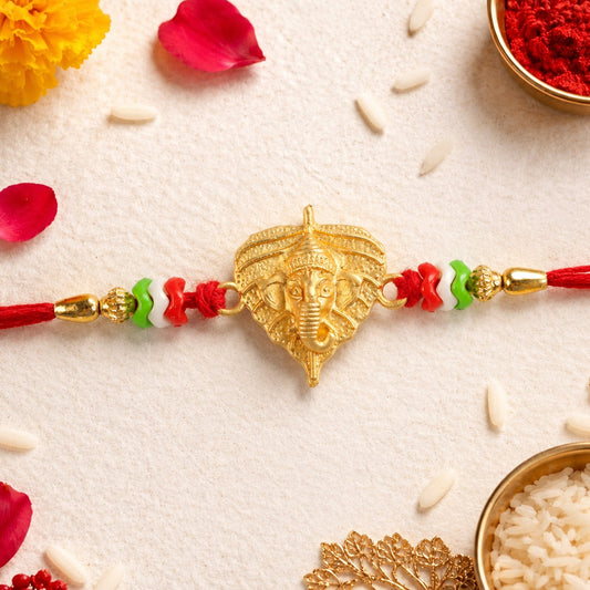 Golden Ganesh Rakhi with paan leaf and multicolor beads design
