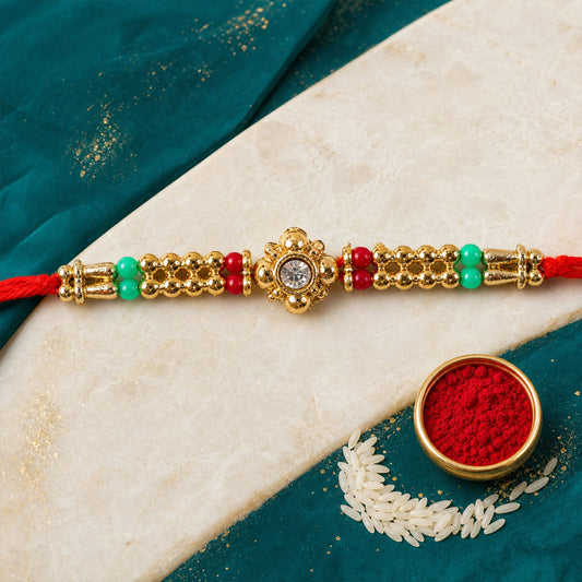 Close up of a single Stone Charm Rakhi with intricate design.