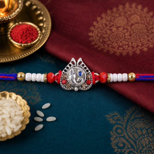 Ganesh motif charm designer rakhi with intricate detailing, perfect for Raksha Bandhan.