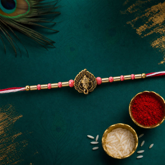 Close up of a Ganesha motif rakhi with leaf and paisley design, suitable for Raksha Bandhan.