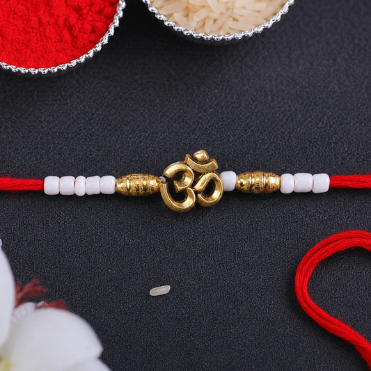 Close up of an Om Symbol Charm Beaded Rakhi with intricate design.
