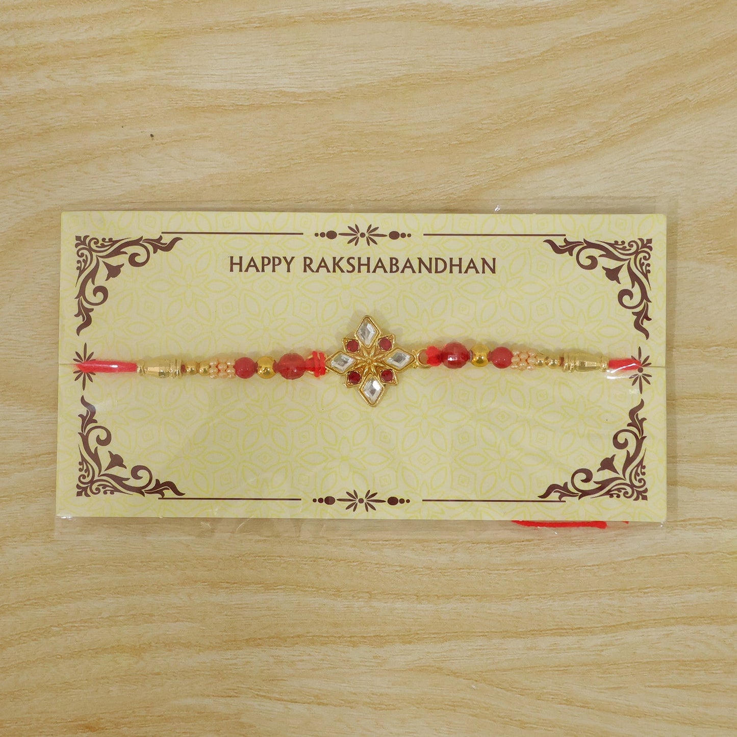 Designer Golden Ganesha Rakhi with Red & Green Beads for Brother | Raksha Bandhan Special