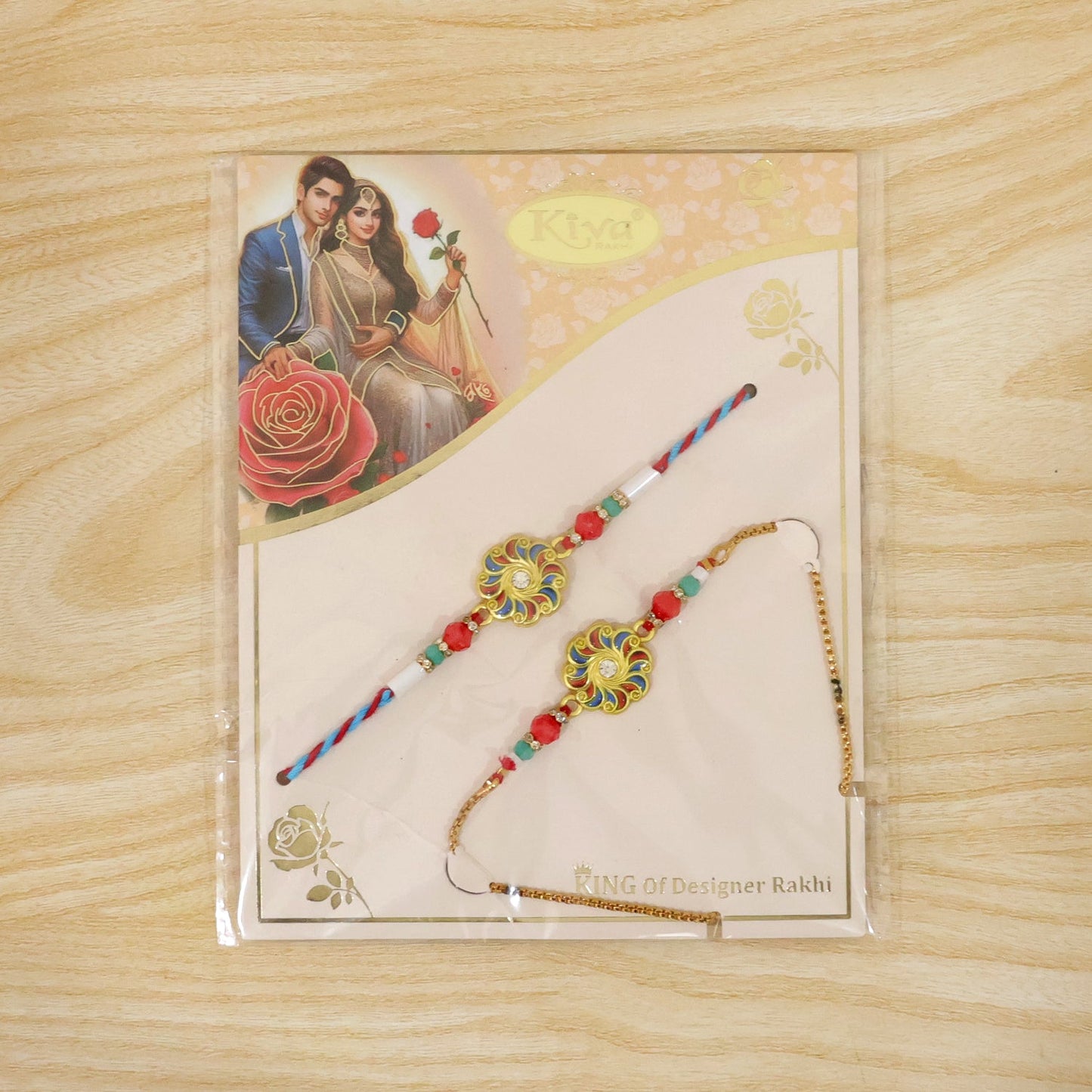 A colorful floral Rakhi and a matching bracelet are packaged on a card featuring an illustration of a couple and roses.