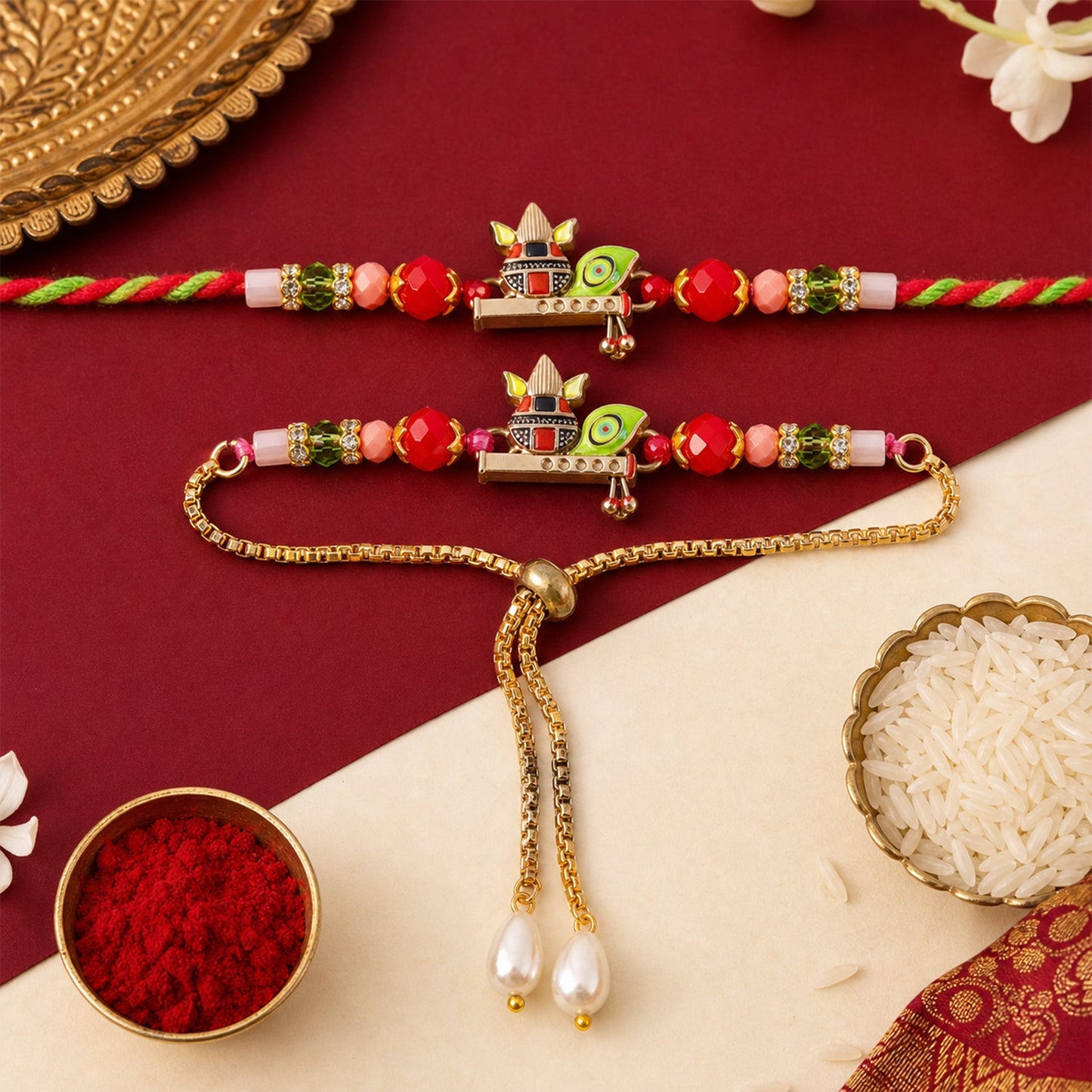 A Kalash motif bracelet set with red and green beads is displayed on a red and white background, with rice and red powder.