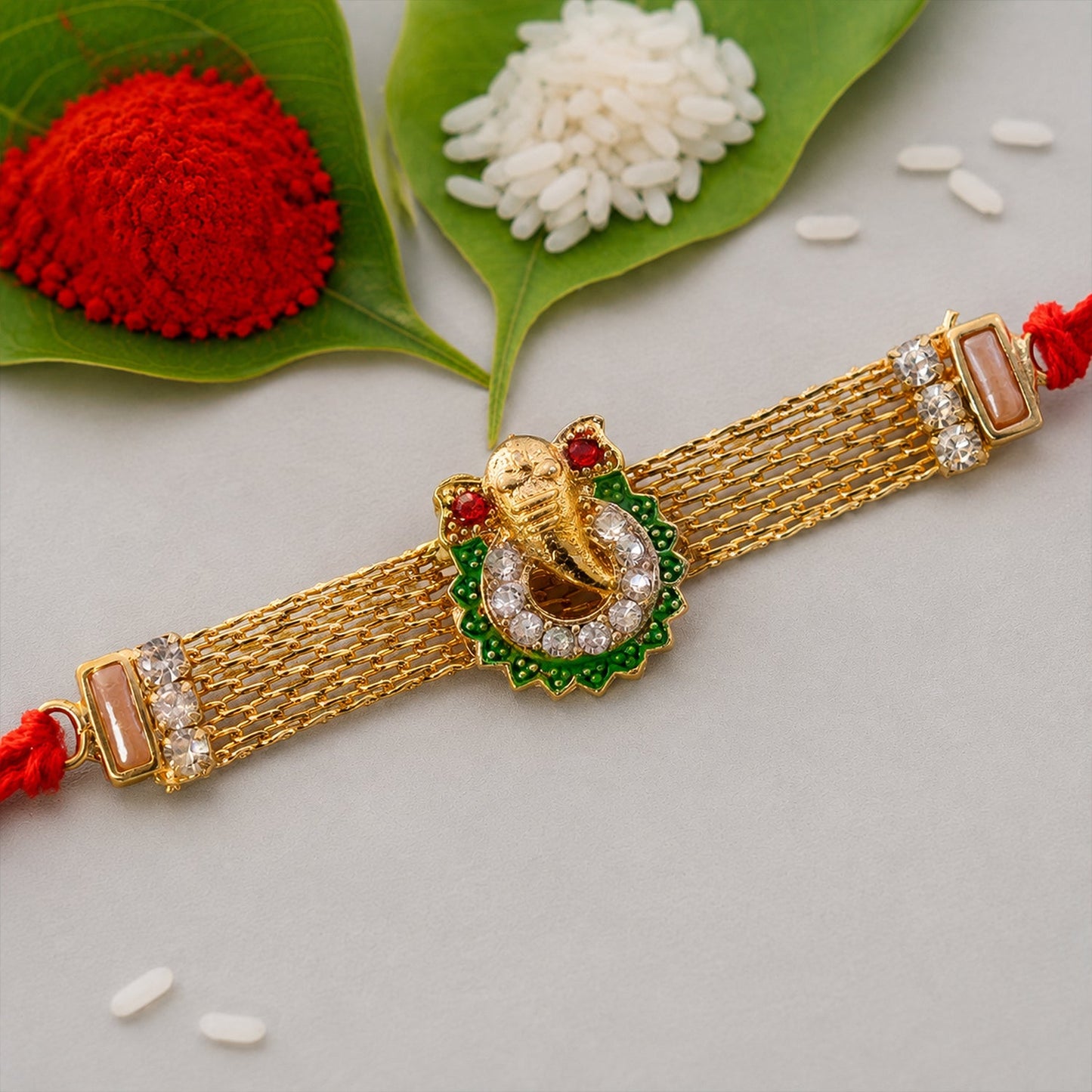 Ganesha Charm Rakhi with Elegant Stone Center Motif Design