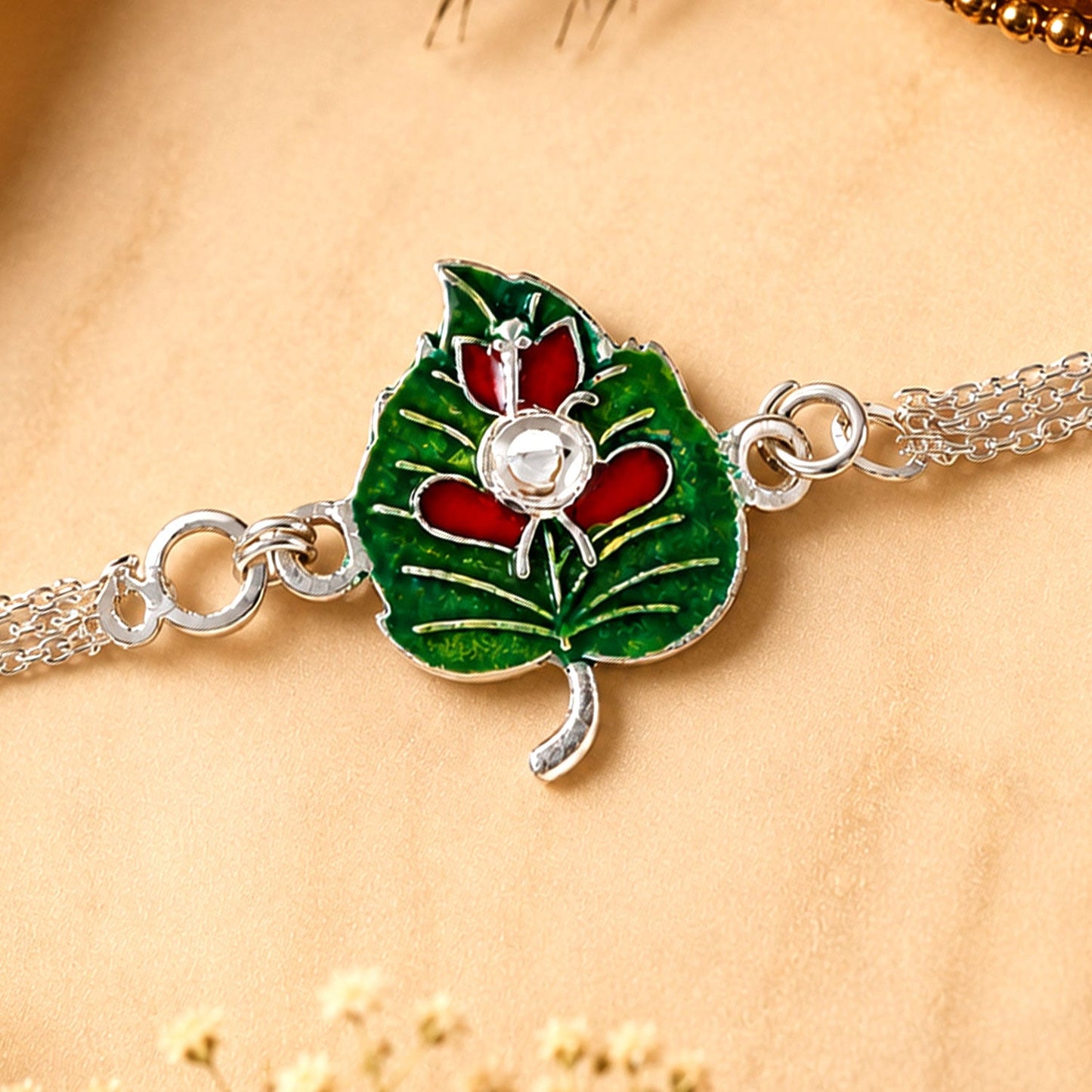 Leaf Ganesha Motif Stone Rakhi with Elegant Chain Center Detail Design
