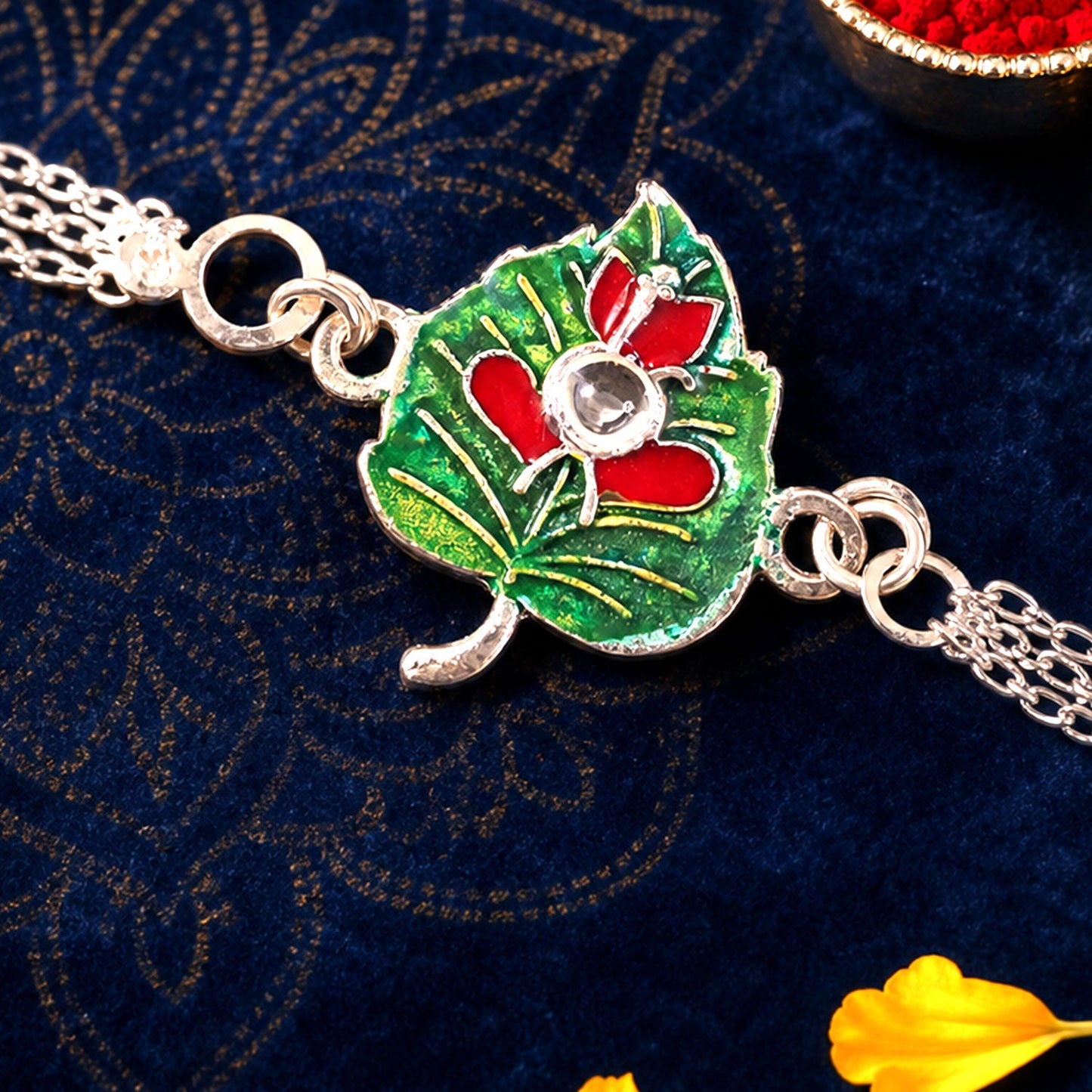 Leaf Ganesha Motif Stone Rakhi with Elegant Chain Center Detail Design