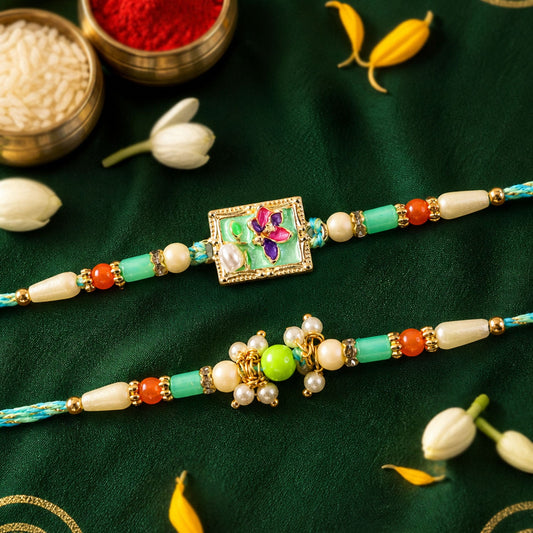 Two colorful friendship bands featuring square floral and round green designs with pearl drops, on a dark green cloth with