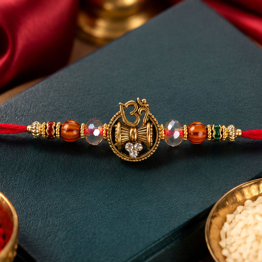 Close-up of Om Damru Trishul Devotional Rakhi with sparkling stones