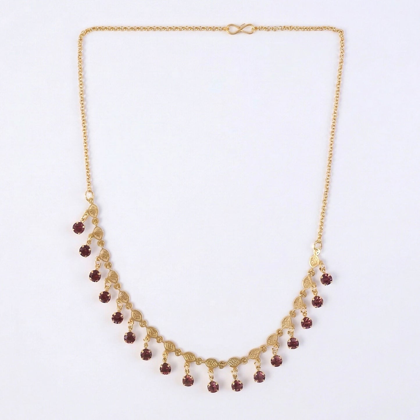 Red stone drop accents on gold plated leaf design necklace