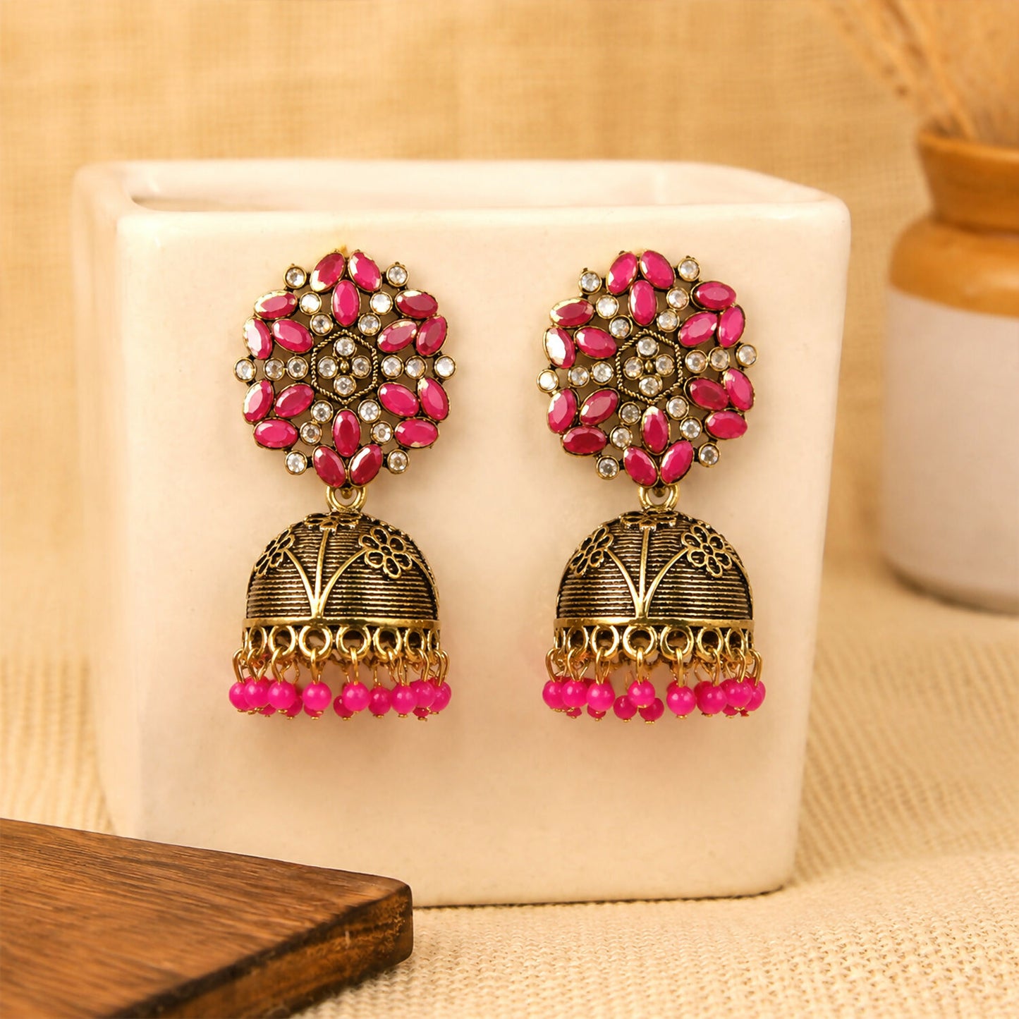 Pink stone floral top on antique gold jhumka earrings