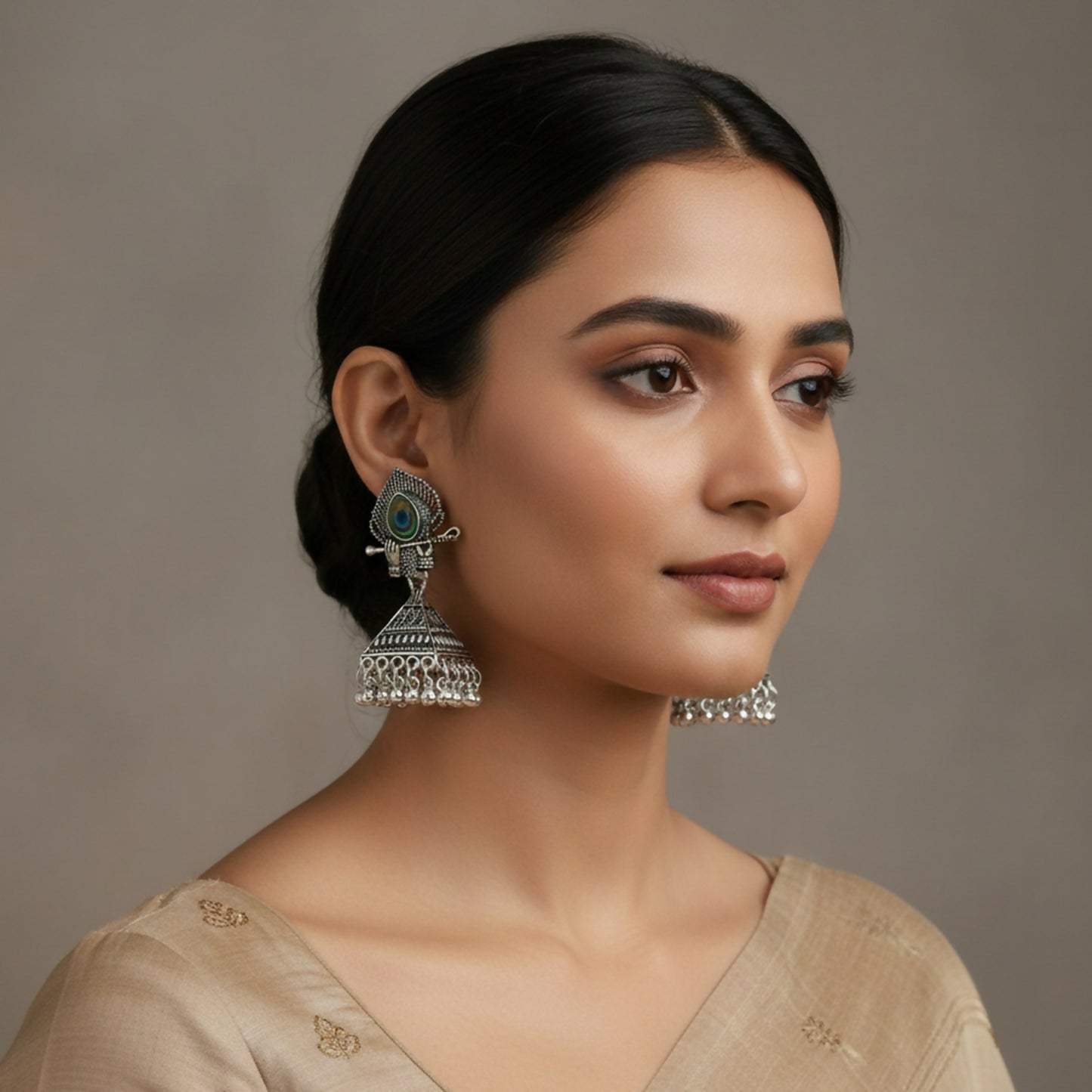 Close-up view of handcrafted oxidised silver Krishna motif jhumka earring