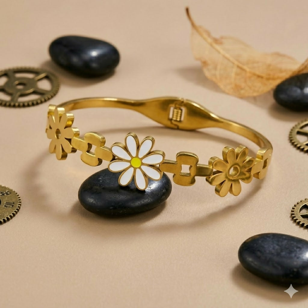 Close-up of gold-tone flower details with enamel centers