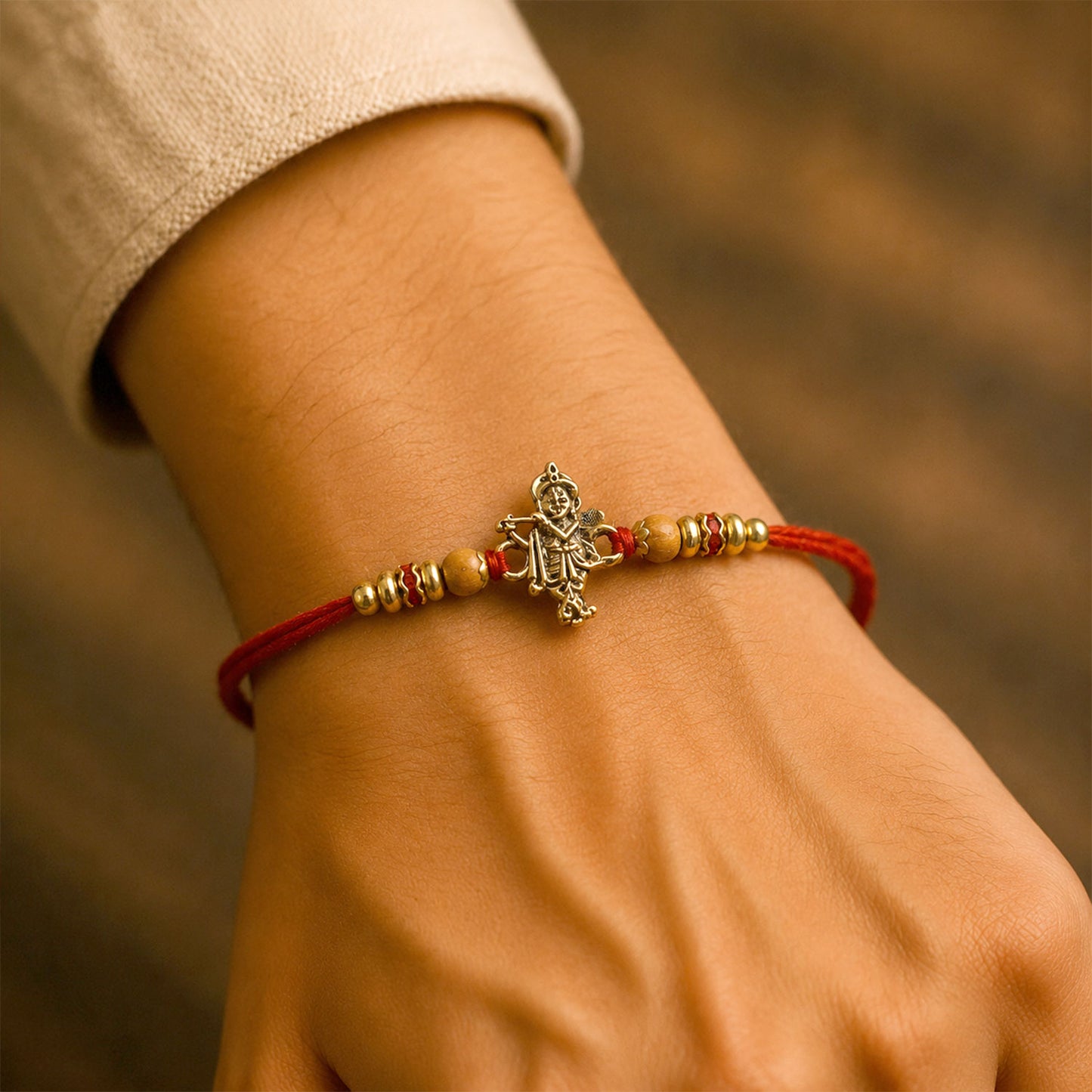 Krishna Flute Idol Devotional Rakhi with Golden Centre, Wooden Beads and Red Thread