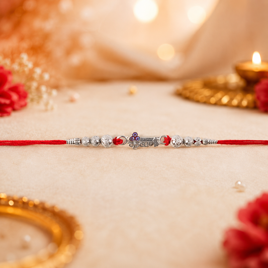 Silver Morpich Krishna Bead Rakhi with Tiny Purple Stone and Red Thread