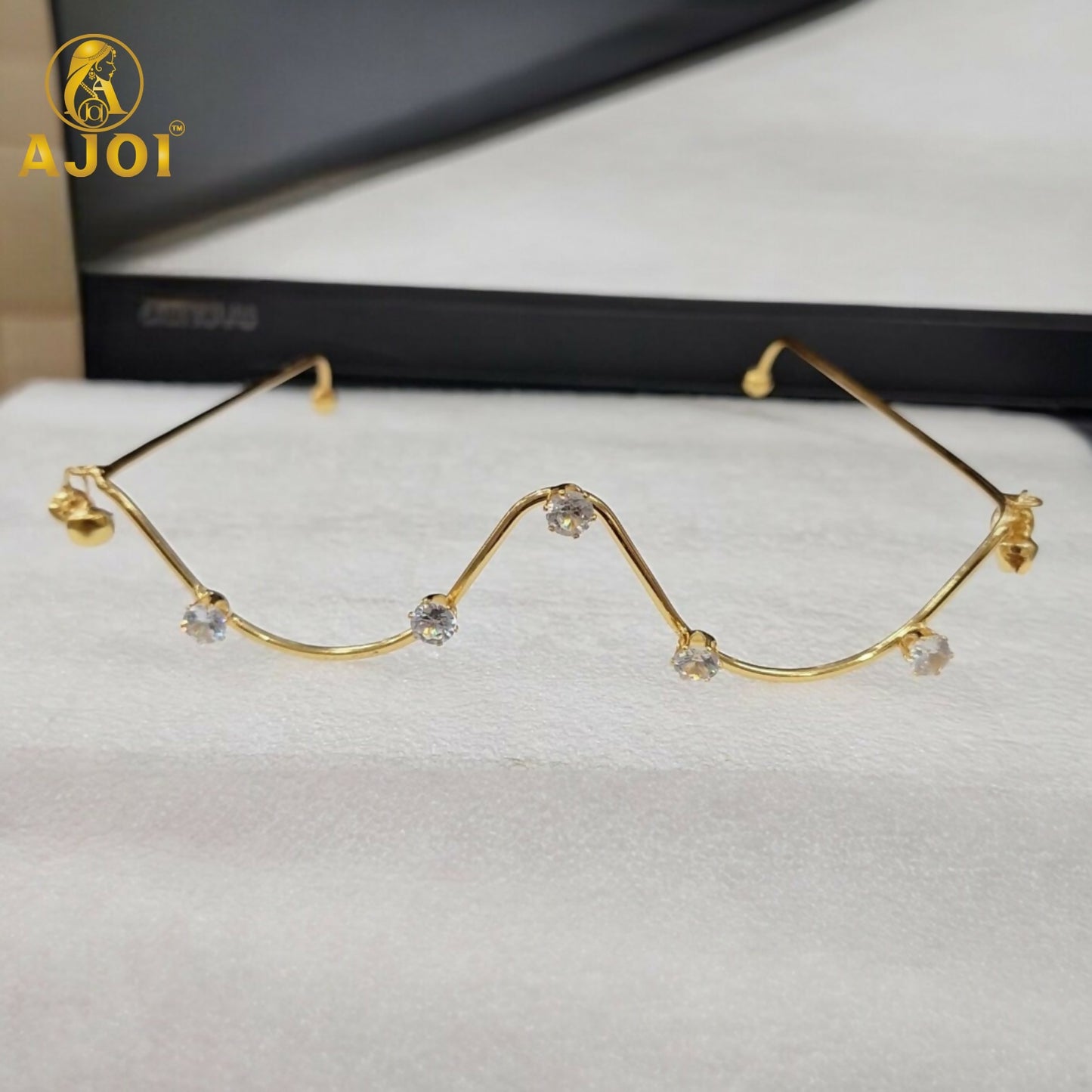 Close up of zigzag crystal detailing on gold plated goggles