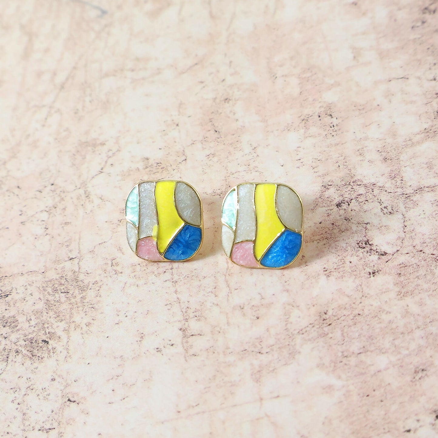 Pair of colorful Korean enamel stud earrings on white background