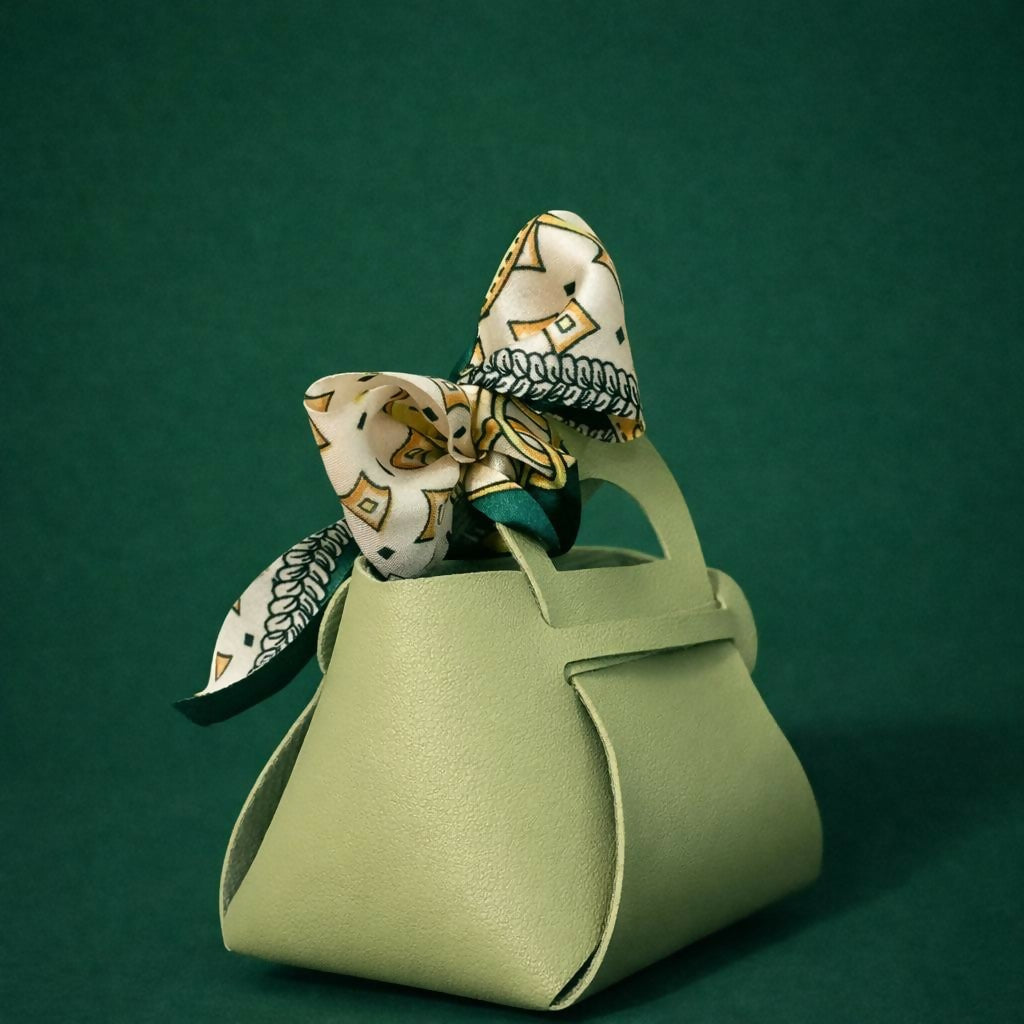 Side view of green handbag organizer with decorative bow