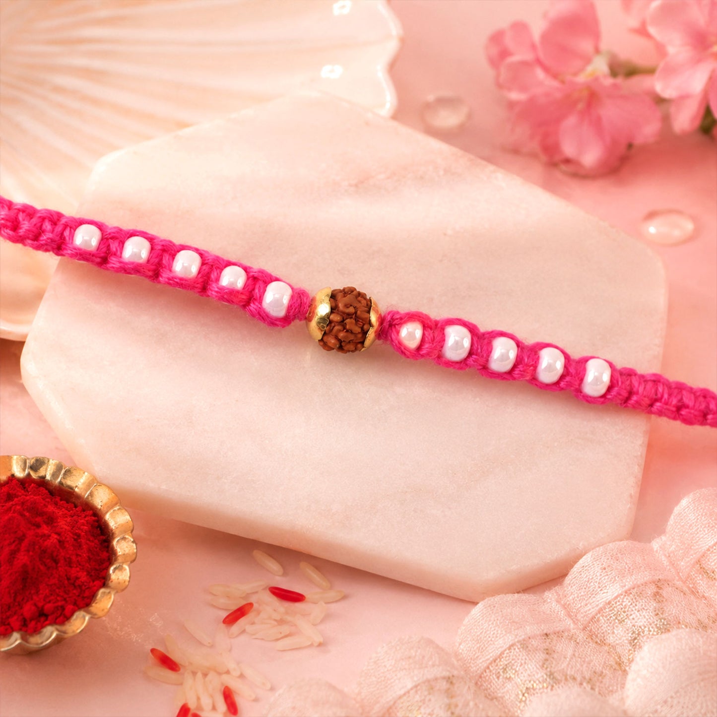 Pink-White Braided Rakhi with Natural Rudraksha Bead Pendant