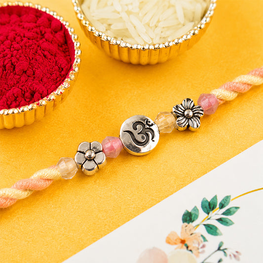 Pastel bracelet rakhi with silver centre detail.