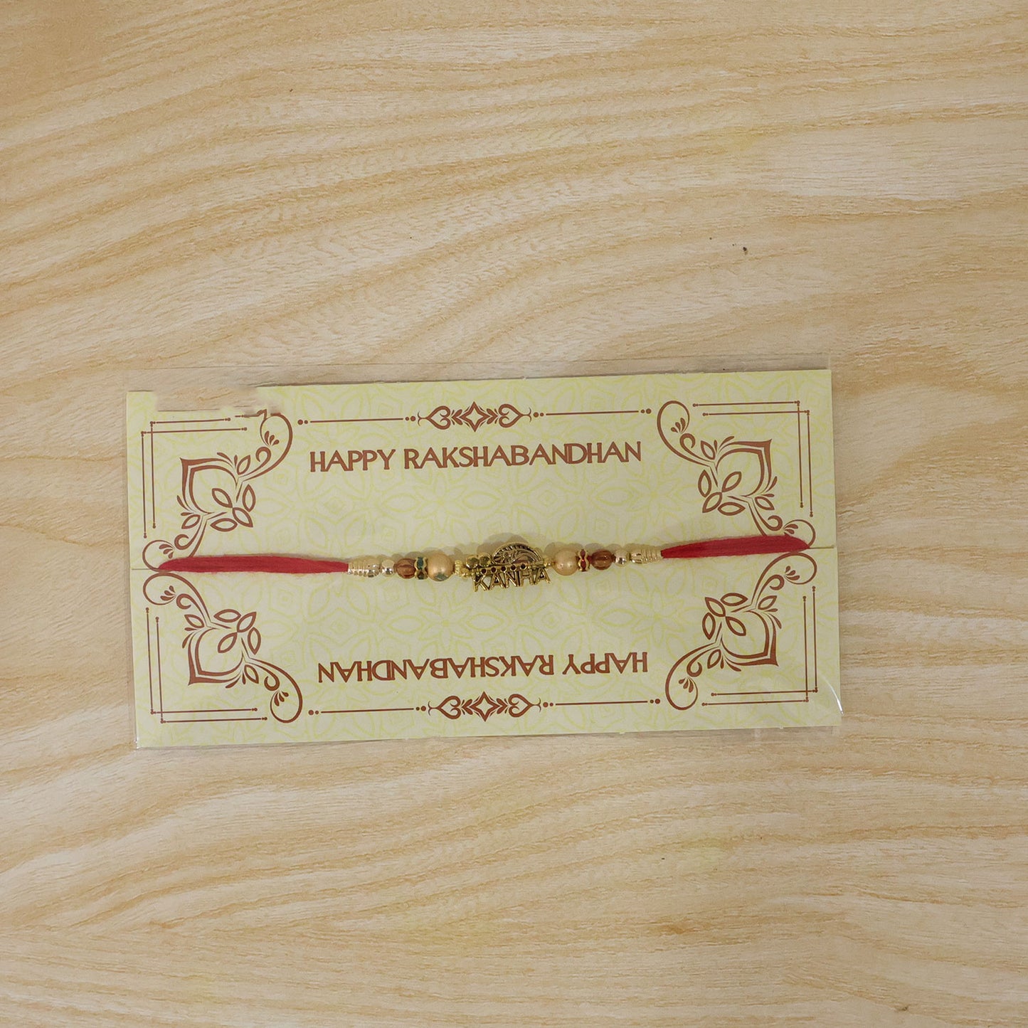 Kanha Krishna Devotional Rakhi with Peacock-Flute Style Golden Centre and Red Beads