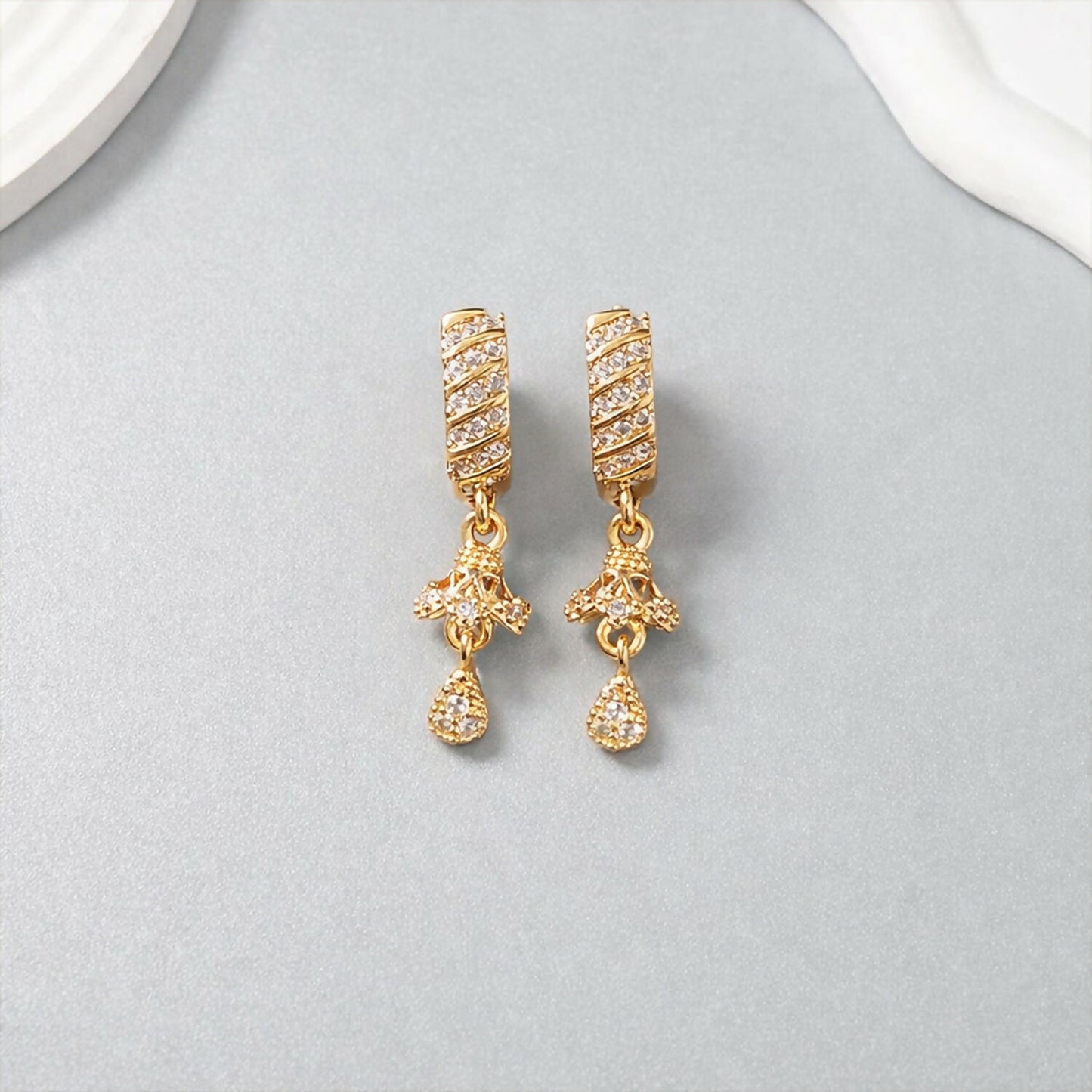 Close-up of elegant spiral bar design with shimmering crystals on dangle earrings