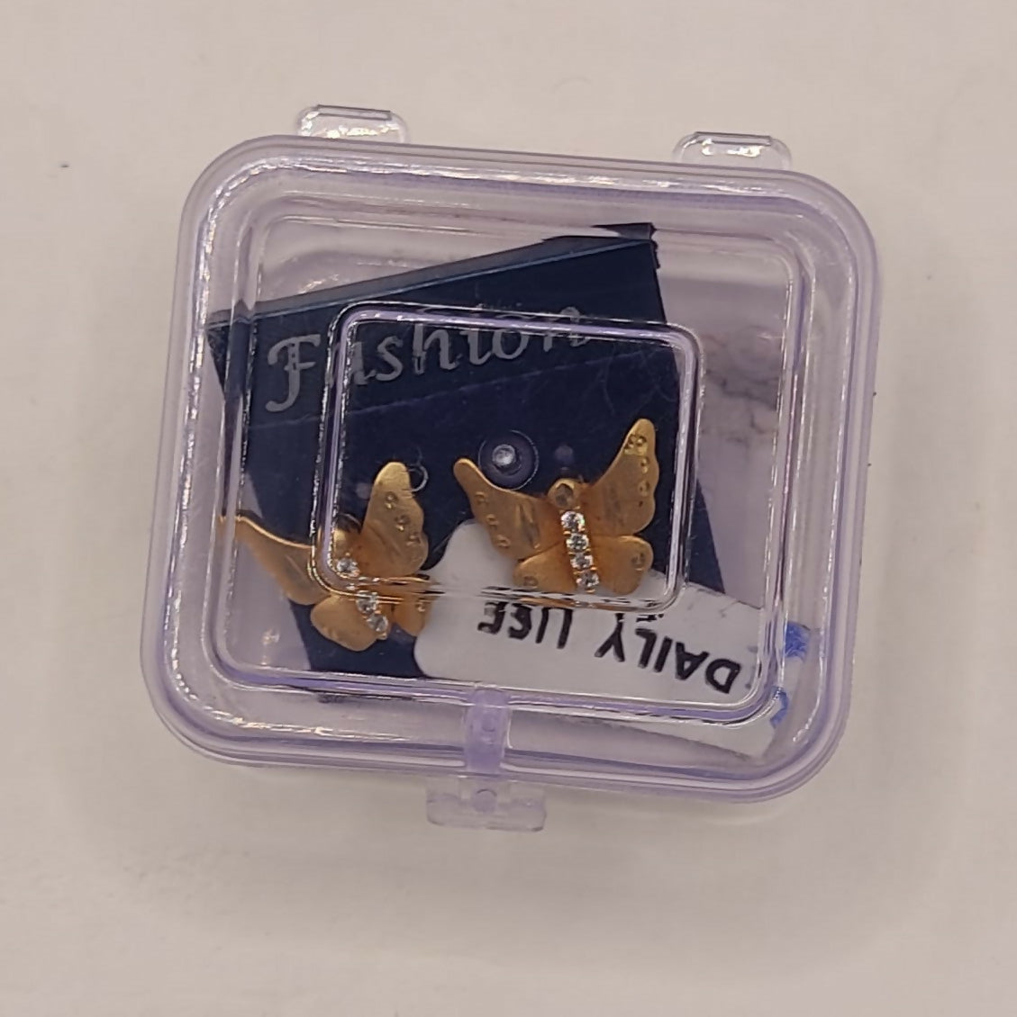 Gold butterfly stud earrings styled for elegant daily wear with sparkling crystal accents