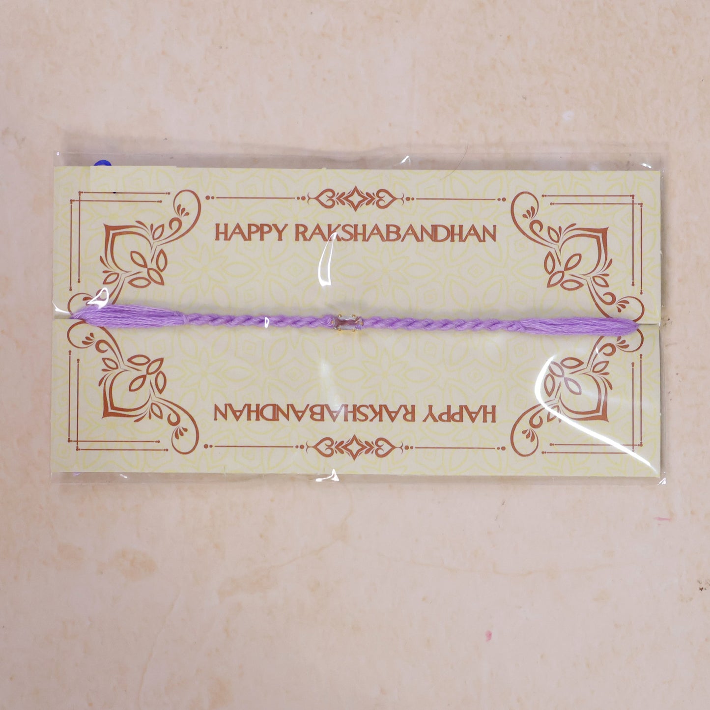 Purple Twisted Cord Rakhi with Rectangular Crystal Stone Pendant