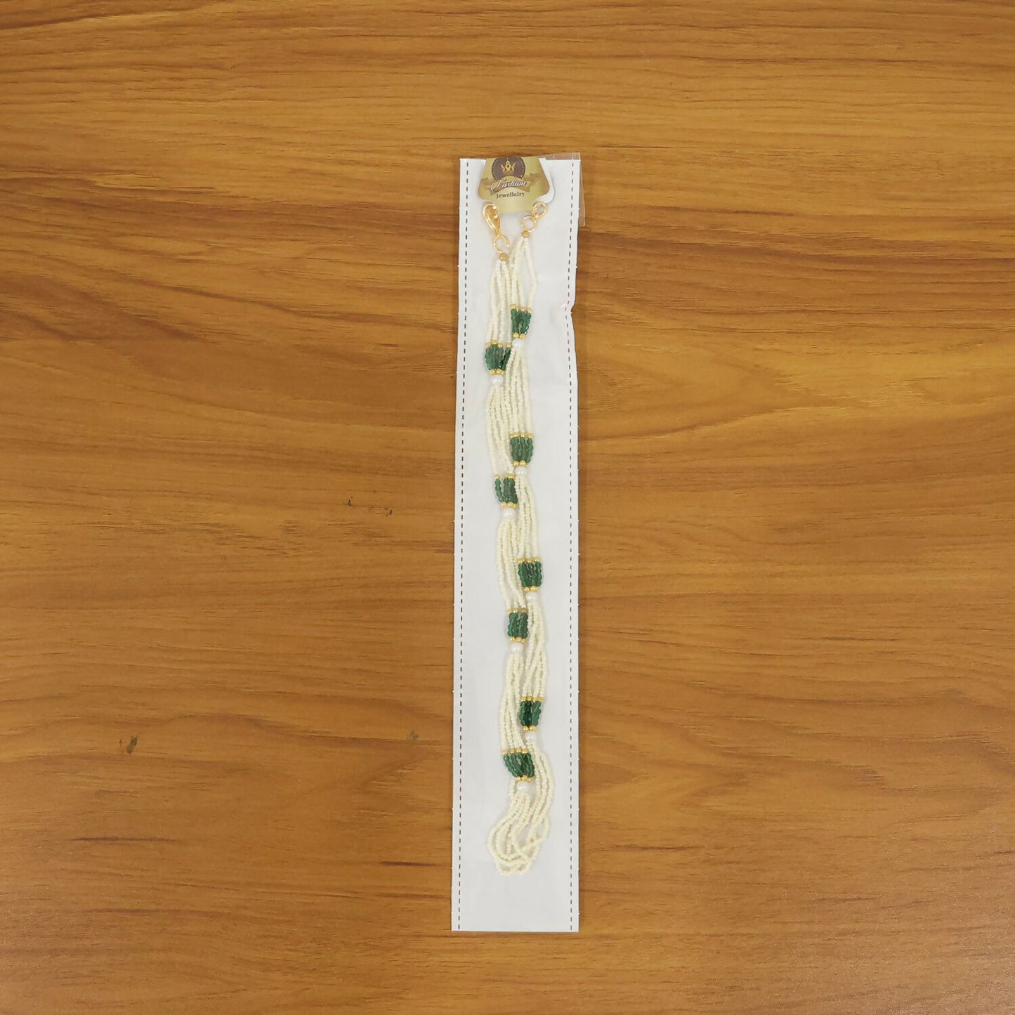 Pearl mala necklace displayed on a wooden surface, highlighting craftsmanship