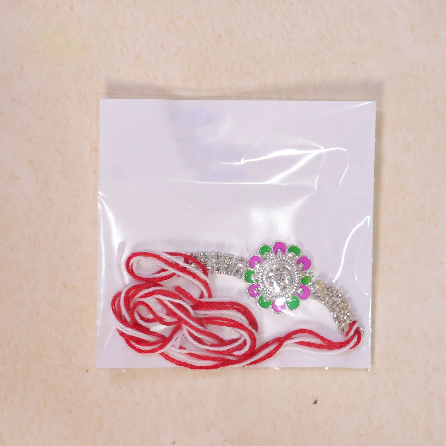 Designer Rakhi featuring Floral Medallion, gold trims and display look for Gift Use