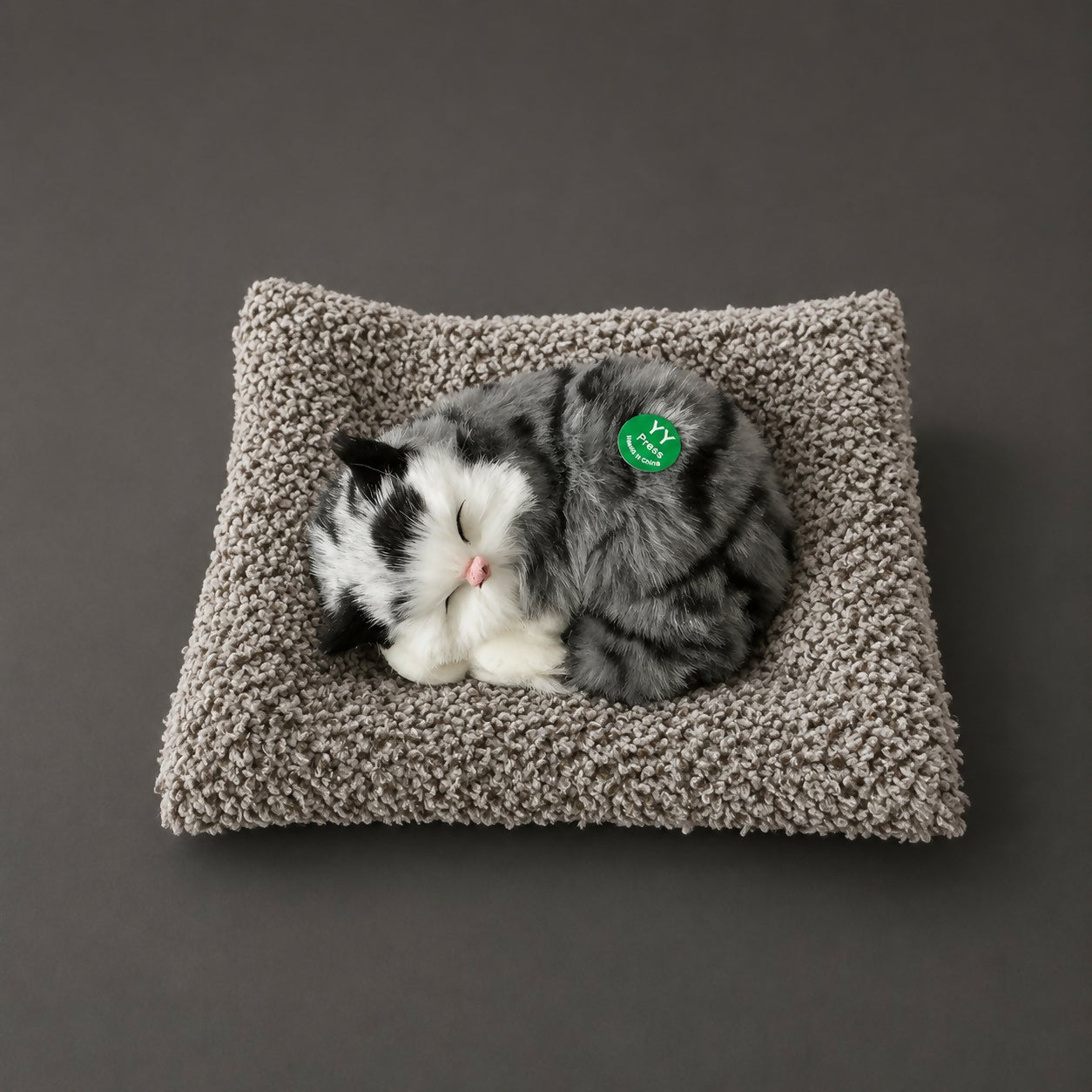 Side view of plush sleeping cat on cushion