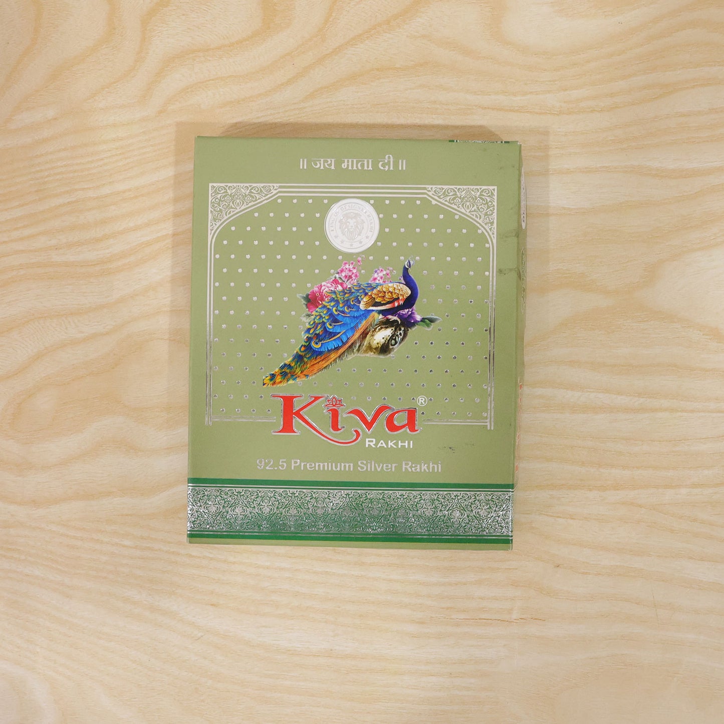 Silver Rakhi with Golden Square Om Centre, Roli Chawal Coin and Peacock Gift Packing