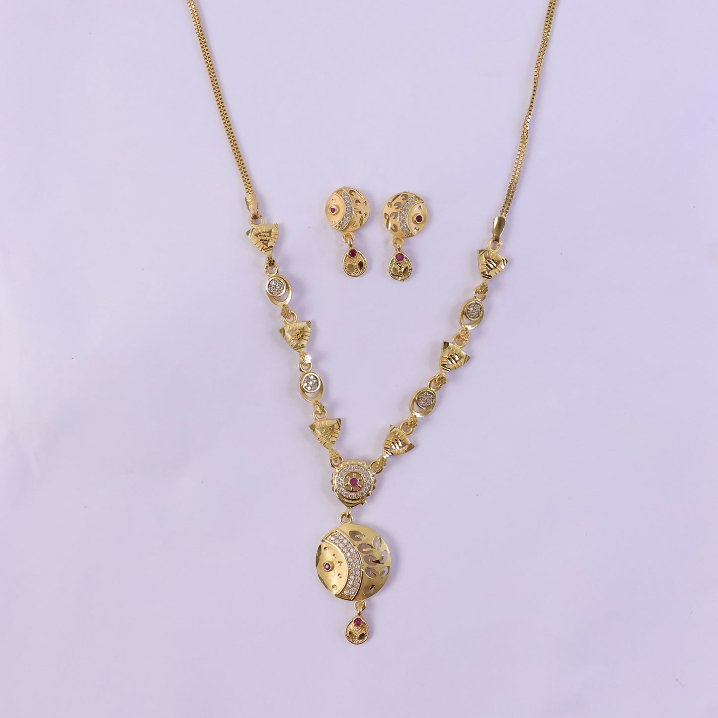 Jewelry set featuring beaded necklace with pendant and earrings in gold tone