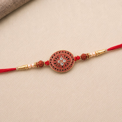 Round Red Chakra Rakhi with Golden Beads and Pearl Side Work