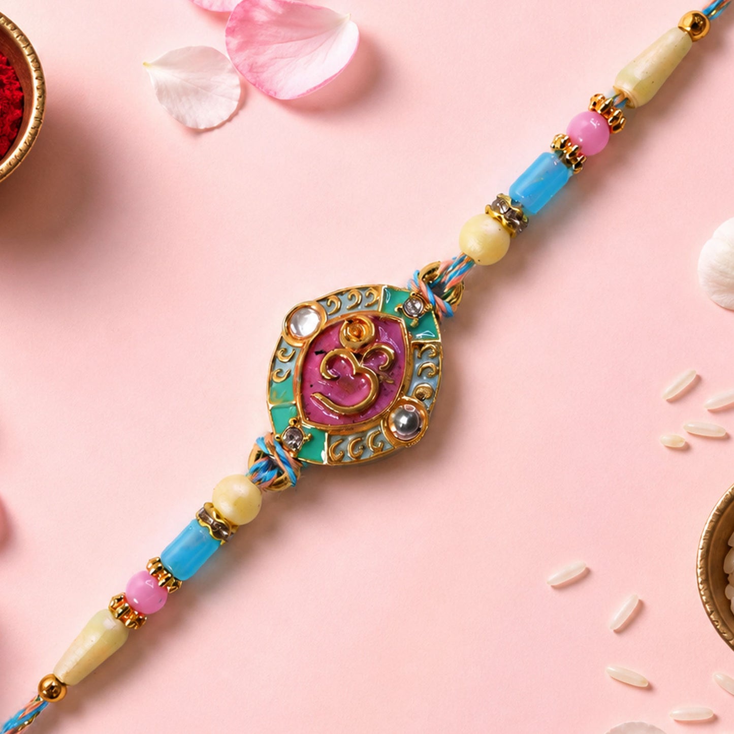 Turquoise Om Pendant Rakhi with Pink Kundan and Pastel Beads