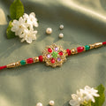 Red and Lilac Kundan Pendant Rakhi with Green Flower Centre