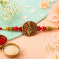 Ganesha Coin Rakhi – Antique Design with Vibrant Red Beads