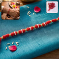 Handmade Red Rakhi with White Beads – Traditional Celebration Accessory
