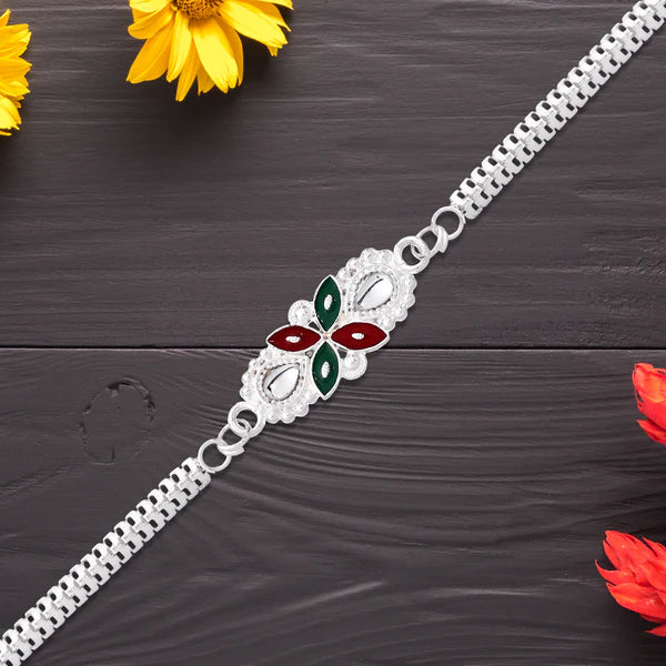 Floral Rakhi placed with roli and chawal, prepared for Raksha Bandhan rituals
