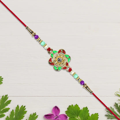 Close up view of the elegant floral motif on the Gold Plated Rakhi.