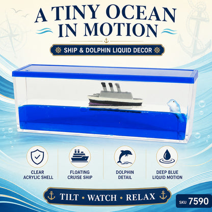 A clear rectangular acrylic box with blue liquid, a white and gray ship, and a small white dolphin inside, with text