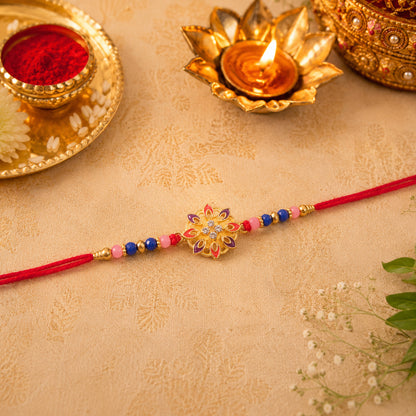 Elegant floral rakhi displayed on white surface