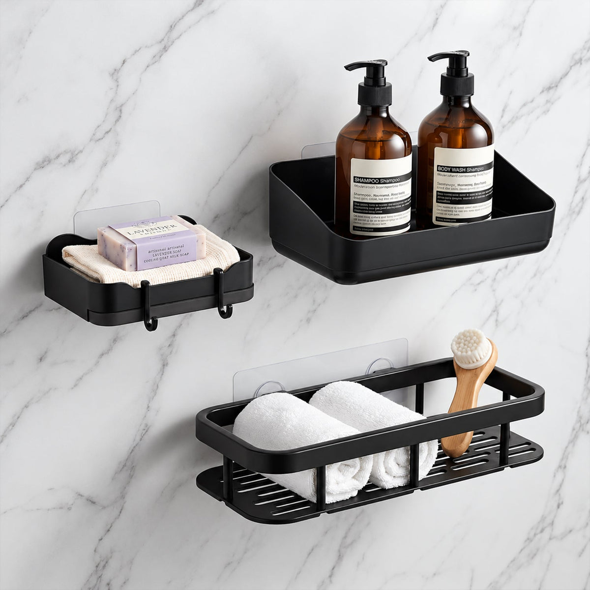 Three black plastic shower caddies displaying soaps, rolled white towels, and a wooden brush on a marble wall.