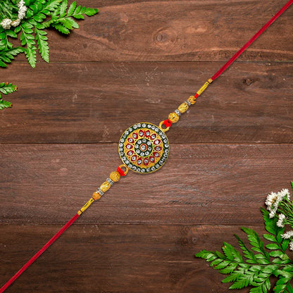 Gift-ready presentation of the royal golden Kundan Rakhi for brothers.