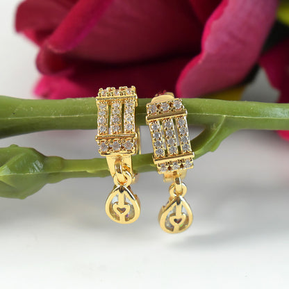 Close-up of sparkling rectangular cubic zirconia stones on stylish drop earrings