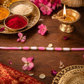 Pink & White Thread Rakhi – Elegant Traditional Beaded Design
