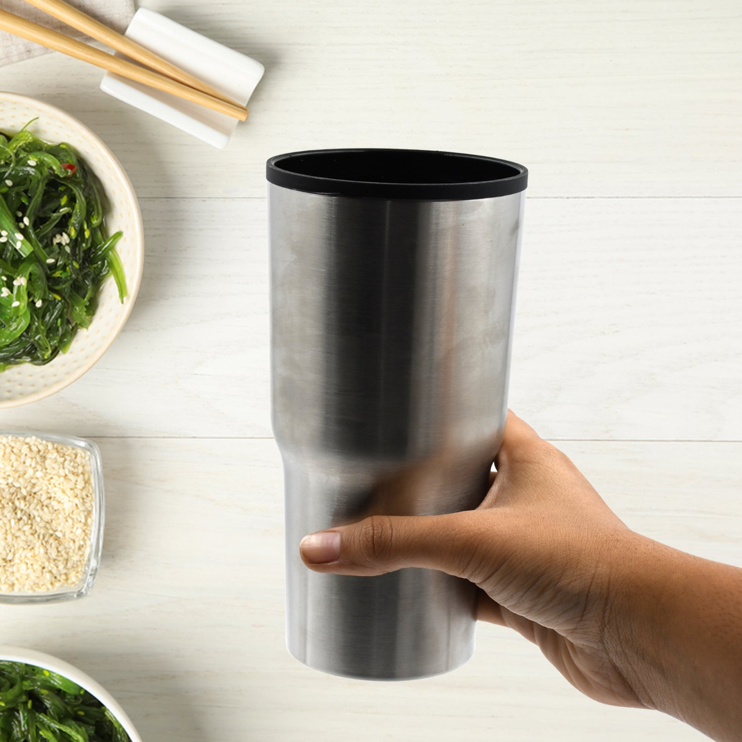 Stainless steel vacuum insulated coffee mug, double-walled design, no lid.